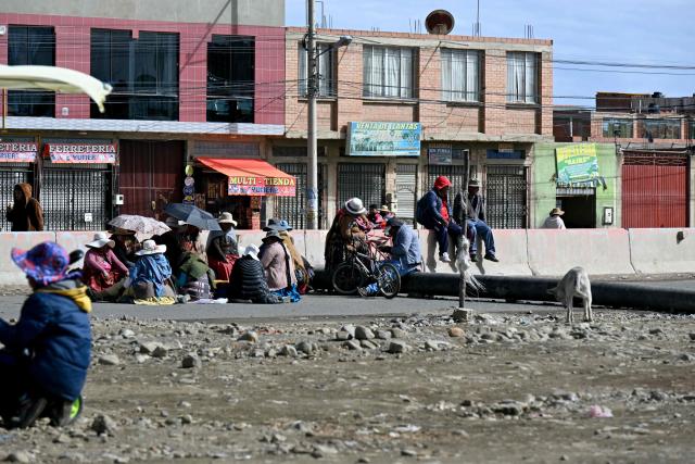 Demonstrators block a road to protst aagainst the government of Bolivian President Rodrigo Paz, in El Alto, Bolivia, on May 23, 2026. The Bolivian government said it would deploy a police and military operation starting on the morning of May 23 to allow the passage of scarce goods into La Paz through roadblocks, as unions and Indigenous groups press their calls for President Rodrigo Paz to step down. (Photo by AIZAR RALDES / AFP)