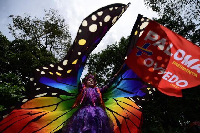 An artist depicting a butterfly performs during a campaign rally for Colombian presidential candidate Paloma Valencia of the Centro Democratico party, in Medellin, Antioquia department, Colombia, on May 23, 2026. (Photo by Jaime SALDARRIAGA / AFP)