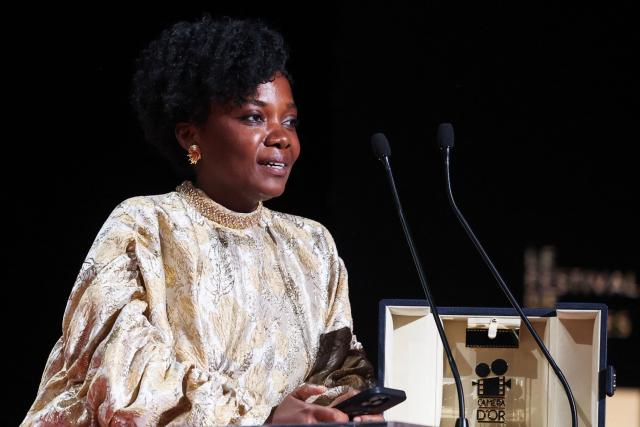 Rwandan director and screenwriter Marie-Clementine Dusabejambo celebrates on stage after winning the Camera d'Or Prize for the film "Ben'Imana" during the closing ceremony of the 79th edition of the Cannes Film Festival in Cannes, southern France, on May 23, 2026. (Photo by Valery HACHE / AFP)