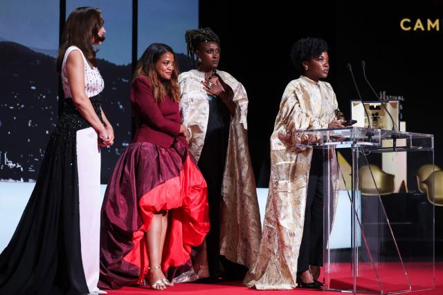 Rwandan director and screenwriter Marie-Clementine Dusabejambo (R) celebrates on stage after winning the Camera d'Or Prize for the film "Ben'Imana" during the closing ceremony of the 79th edition of the Cannes Film Festival in Cannes, southern France, on May 23, 2026. (Photo by Valery HACHE / AFP)