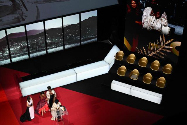 Rwandan director and screenwriter Marie-Clementine Dusabejambo (C) celebrates on stage after winning the Camera d'Or Prize for the film "Ben'Imana" during the closing ceremony of the 79th edition of the Cannes Film Festival in Cannes, southern France, on May 23, 2026. (Photo by Antonin THUILLIER / AFP)