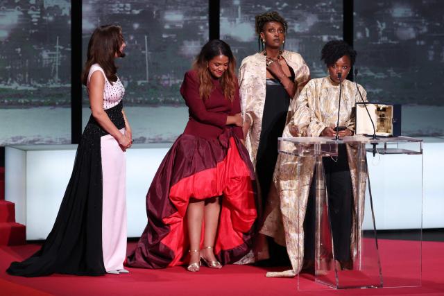 Rwandan actress Isabelle Kabano (2R) and Rwandan director and screenwriter Marie-Clementine Dusabejambo (R) celebrate on stage after winning the Camera d'Or Prize for the film "" during the closing ceremony of the 79th edition of the Cannes Film Festival in Cannes, southern France, on May 23, 2026. (Photo by Sameer AL-DOUMY / AFP)