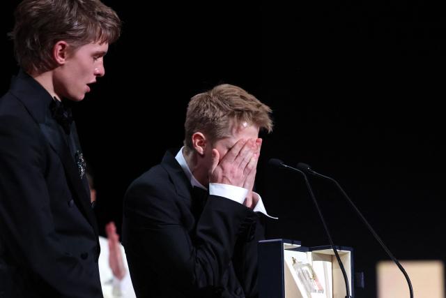 Belgian actor Emmanuel Macchia (L) and French actor Valentin Campagne celebrate on stage after winning ex-aequo the Best Actor Prize for the film "Coward" during the closing ceremony of the 79th edition of the Cannes Film Festival in Cannes, southern France, on May 23, 2026. (Photo by Valery HACHE / AFP)