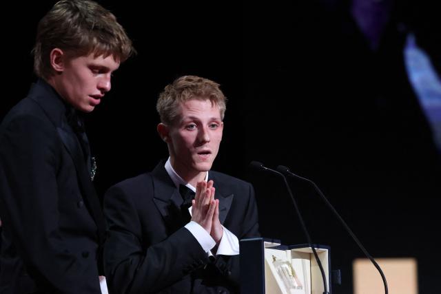 Belgian actor Emmanuel Macchia (L) and French actor Valentin Campagne celebrate on stage after winning ex-aequo the Best Actor Prize for the film "Coward" during the closing ceremony of the 79th edition of the Cannes Film Festival in Cannes, southern France, on May 23, 2026. (Photo by Valery HACHE / AFP)