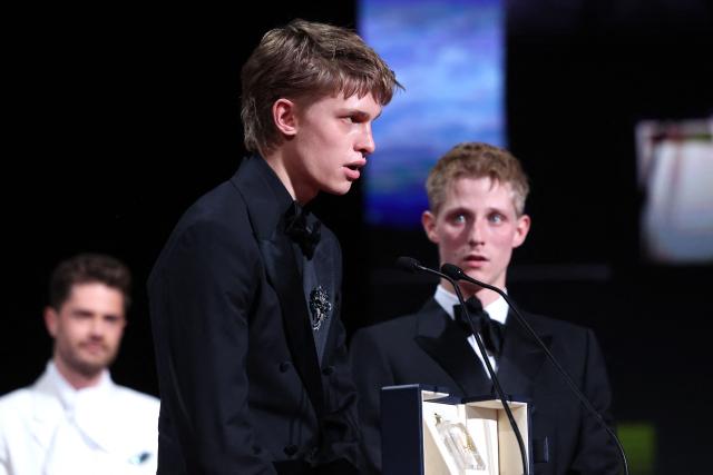 Belgian actor Emmanuel Macchia (L) and French actor Valentin Campagne celebrate on stage after winning ex-aequo the Best Actor Prize for the film "Coward" during the closing ceremony of the 79th edition of the Cannes Film Festival in Cannes, southern France, on May 23, 2026. (Photo by Valery HACHE / AFP)