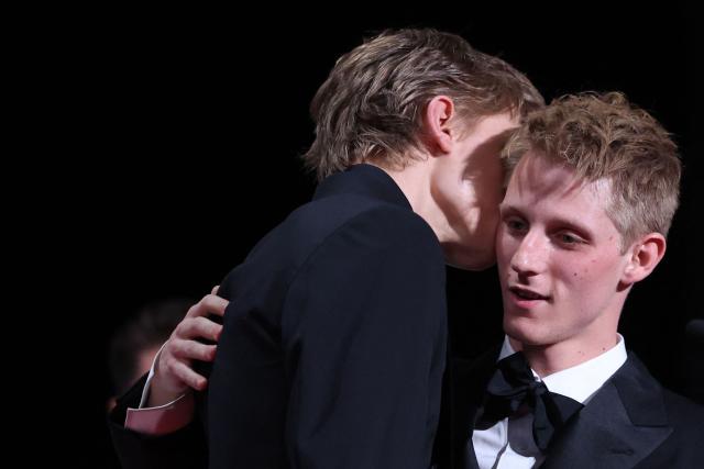 Belgian actor Emmanuel Macchia (L) and French actor Valentin Campagne celebrate on stage after winning ex-aequo the Best Actor Prize for the film "Coward" during the closing ceremony of the 79th edition of the Cannes Film Festival in Cannes, southern France, on May 23, 2026. (Photo by Valery HACHE / AFP)