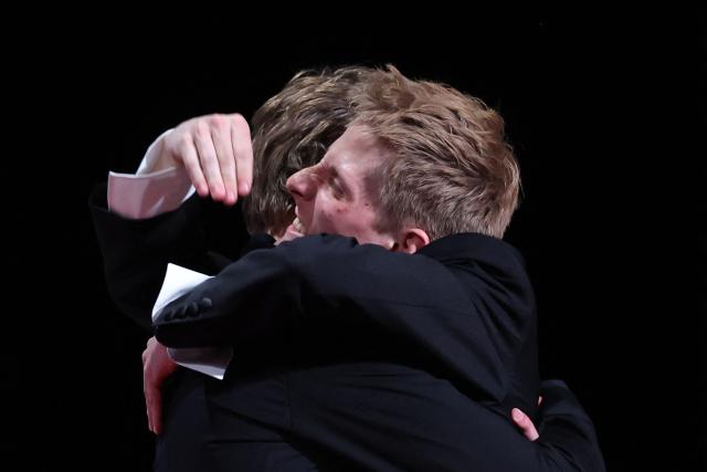 Belgian actor Emmanuel Macchia (L) and French actor Valentin Campagne celebrate on stage after winning ex-aequo the Best Actor Prize for the film "Coward" during the closing ceremony of the 79th edition of the Cannes Film Festival in Cannes, southern France, on May 23, 2026. (Photo by Valery HACHE / AFP)