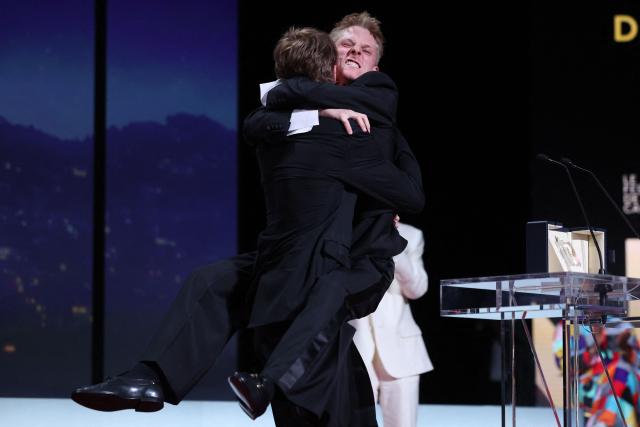 Belgian actor Emmanuel Macchia (L) and French actor Valentin Campagne celebrate on stage after winning ex-aequo the Best Actor Prize for the film "Coward" during the closing ceremony of the 79th edition of the Cannes Film Festival in Cannes, southern France, on May 23, 2026. (Photo by Valery HACHE / AFP)