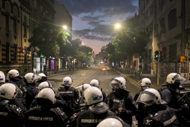 Riot police stand in a street during clashes that erupt at the end of an anti-government protest decrying corruption and calling for early elections following the collapse of a railway station canopy in Novi Sad that killed 16 in November 2024, in central Belgrade on May 23, 2026. (Photo by OLIVER BUNIC / AFP)