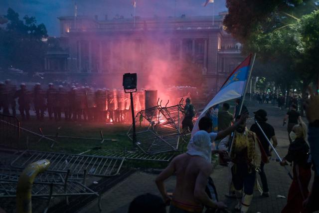 A group of demonstrators clash with riot police outside Serbia's parliament building at the end of an anti-government protest decrying corruption and calling for early elections following the collapse of a railway station canopy in Novi Sad that killed 16 in November 2024, in central Belgrade on May 23, 2026. (Photo by OLIVER BUNIC / AFP)