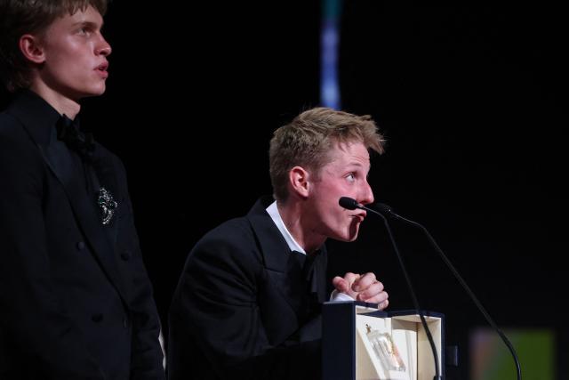 Belgian actor Emmanuel Macchia (L) and French actor Valentin Campagne celebrate on stage after winning ex-aequo the Best Actor Prize for the film "Coward" during the closing ceremony of the 79th edition of the Cannes Film Festival in Cannes, southern France, on May 23, 2026. (Photo by Valery HACHE / AFP)