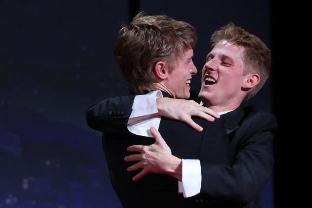 Belgian actor Emmanuel Macchia (L) and French actor Valentin Campagne celebrate on stage after winning ex-aequo the Best Actor Prize for the film "Coward" during the closing ceremony of the 79th edition of the Cannes Film Festival in Cannes, southern France, on May 23, 2026. (Photo by Valery HACHE / AFP)