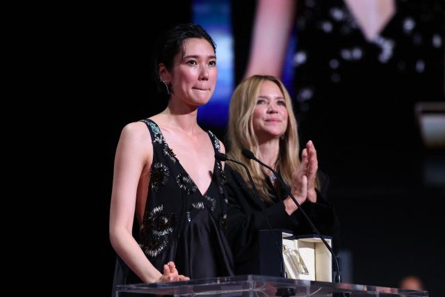 Japanese actress Tao Okamoto (L) and Belgian actress Virginie Efira celebrate on stage after winning ex-aequo the Best Actress Prize for the film "Soudain" (All of a Sudden) during the closing ceremony of the 79th edition of the Cannes Film Festival in Cannes, southern France, on May 23, 2026. (Photo by Valery HACHE / AFP)