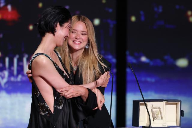 Japanese actress Tao Okamoto (L) and Belgian actress Virginie Efira celebrate on stage after winning ex-aequo the Best Actress Prize for the film "Soudain" (All of a Sudden) during the closing ceremony of the 79th edition of the Cannes Film Festival in Cannes, southern France, on May 23, 2026. (Photo by Sameer AL-DOUMY / AFP)