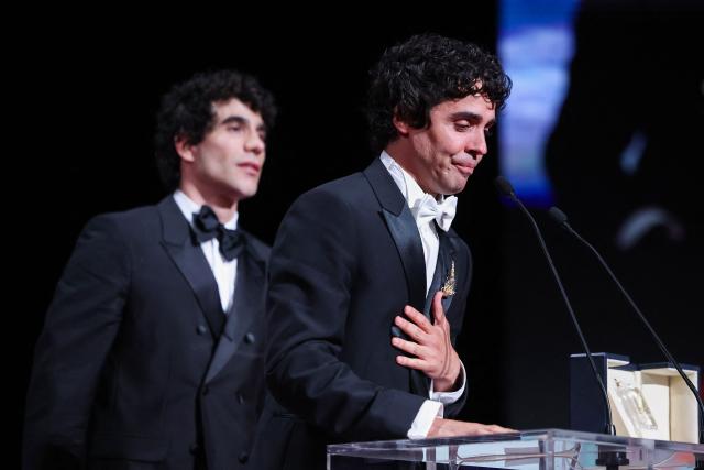 Spanish director, screenwriter and producer Javier Ambrossi (R) and Spanish director, screenwriter and producer Javier Calvo celebrate on stage after winning the Best Director Prize for the film "La Bola Negra" during the closing ceremony of the 79th edition of the Cannes Film Festival in Cannes, southern France, on May 23, 2026. (Photo by Valery HACHE / AFP)