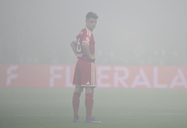 Bayern Munich's German midfielder #06 Joshua Kimmich stands in the smoke from flares after the match was interrupted during the German Cup (DFB Pokal) final football match FC Bayern Munich v VfB Stuttgart at the Olympic Stadium in Berlin, on May 23, 2026. (Photo by John MACDOUGALL / AFP) / DFB REGULATIONS PROHIBIT ANY USE OF PHOTOGRAPHS AS IMAGE SEQUENCES AND QUASI-VIDEO.