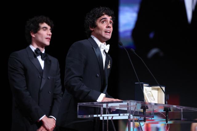 Spanish director, screenwriter and producer Javier Ambrossi (R) and Spanish director, screenwriter and producer Javier Calvo celebrate on stage after winning the Best Director Prize for the film "La Bola Negra" during the closing ceremony of the 79th edition of the Cannes Film Festival in Cannes, southern France, on May 23, 2026. (Photo by Valery HACHE / AFP)