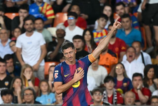 Barcelona's Polish forward #09 Robert Lewandowski celebrates scoring his team's first goal during the Spanish league football match between Valencia CF and FC Barcelona at Mestalla Stadium in Valencia on May 23, 2026. (Photo by JOSE JORDAN / AFP)