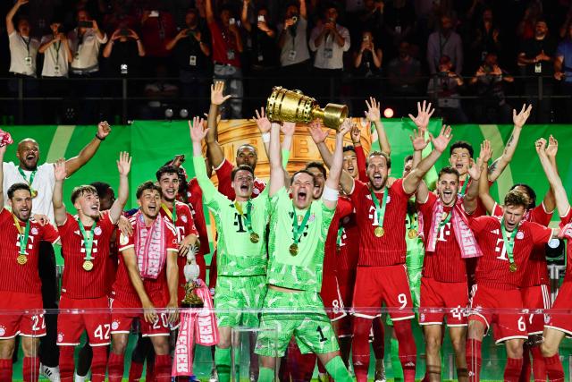 Bayern Munich's German goalkeeper #01 Manuel Neuer lifts the trophy after the German Cup (DFB Pokal) final football match FC Bayern Munich v VfB Stuttgart at the Olympic Stadium in Berlin, on May 23, 2026. (Photo by John MACDOUGALL / AFP) / DFB REGULATIONS PROHIBIT ANY USE OF PHOTOGRAPHS AS IMAGE SEQUENCES AND QUASI-VIDEO.