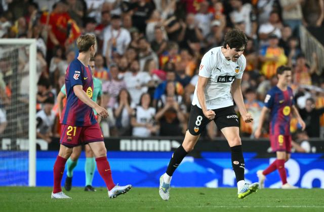 Valencia's Spanish midfielder # 08 Javi Guerra celebrates scoring his team's first goal during the Spanish league football match between Valencia CF and FC Barcelona at Mestalla Stadium in Valencia on May 23, 2026. (Photo by JOSE JORDAN / AFP)