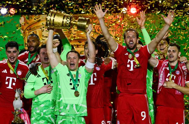 Bayern Munich's German goalkeeper #01 Manuel Neuer lifts the trophy after the German Cup (DFB Pokal) final football match FC Bayern Munich v VfB Stuttgart at the Olympic Stadium in Berlin, on May 23, 2026. (Photo by John MACDOUGALL / AFP) / DFB REGULATIONS PROHIBIT ANY USE OF PHOTOGRAPHS AS IMAGE SEQUENCES AND QUASI-VIDEO.