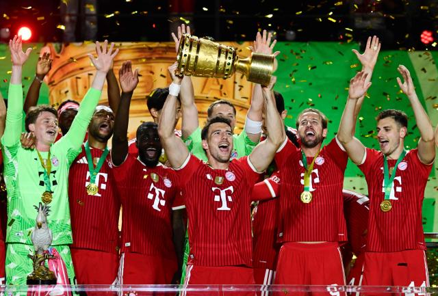 Bayern Munich's German midfielder #08 Leon Goretzka lifts the trophy after the German Cup (DFB Pokal) final football match FC Bayern Munich v VfB Stuttgart at the Olympic Stadium in Berlin, on May 23, 2026. (Photo by John MACDOUGALL / AFP) / DFB REGULATIONS PROHIBIT ANY USE OF PHOTOGRAPHS AS IMAGE SEQUENCES AND QUASI-VIDEO.