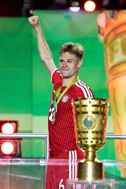 Bayern Munich's German midfielder #06 Joshua Kimmich celebrates next to the trophy after the German Cup (DFB Pokal) final football match FC Bayern Munich v VfB Stuttgart at the Olympic Stadium in Berlin, on May 23, 2026. (Photo by Tobias SCHWARZ / AFP) / ALTERNATIVE CROP