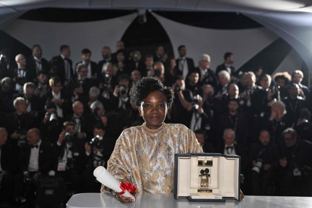 Rwandan director and screenwriter Marie-Clementine Dusabejambo poses with the trophy during a photocall after winning the Camera d'Or Prize for the film "Ben'Imana" during the closing ceremony of the 79th edition of the Cannes Film Festival in Cannes, southern France, on May 23, 2026. (Photo by Olivier CHASSIGNOLE / AFP)