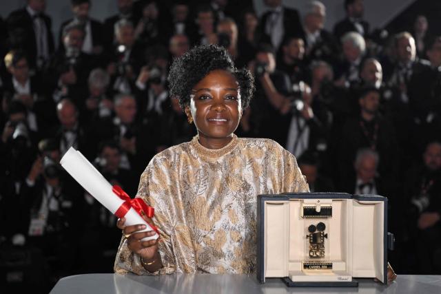 Rwandan director and screenwriter Marie-Clementine Dusabejambo poses with the trophy during a photocall after winning the Camera d'Or Prize for the film "Ben'Imana" during the closing ceremony of the 79th edition of the Cannes Film Festival in Cannes, southern France, on May 23, 2026. (Photo by Olivier CHASSIGNOLE / AFP)