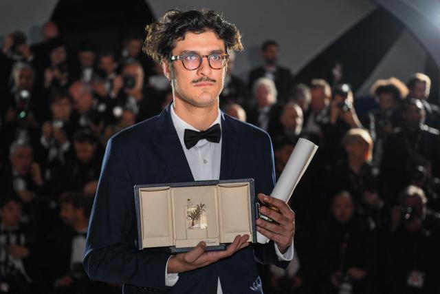 Argentine director Federico Luis poses with the trophy during a photocall after winning the Short Film Palme d'Or for the film "For the Opponents" (Para los contrincantes) during the closing ceremony of the 79th edition of the Cannes Film Festival in Cannes, southern France, on May 23, 2026. (Photo by Olivier CHASSIGNOLE / AFP)