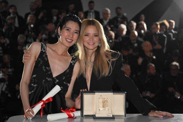 Japanese actress Tao Okamoto (L) and Belgian actress Virginie Efira pose with the trophy during a photocall after winning ex-eaquo the Best Actress Prize for the film "Soudain" (All of a Sudden) during the closing ceremony of the 79th edition of the Cannes Film Festival in Cannes, southern France, on May 23, 2026. (Photo by Olivier CHASSIGNOLE / AFP)