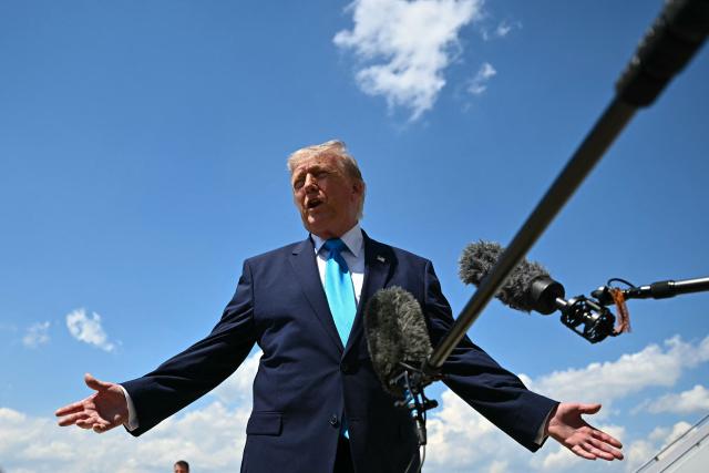 (FILES) US President Donald Trump speaks to reporters after stepping off Air Force One at Joint Base Andrews, Maryland on May 20, 2026, as he returns to Washington, DC, after delivering the commmencement address to the US Coast Guard Academy's 2026 graduating class. US President Donald Trump said on May 23 a deal with Iran had been "largely negotiated," with the proposal including opening the crucial Strait of Hormuz, though the agreement was "subject to finalization." (Photo by Kent NISHIMURA / AFP)