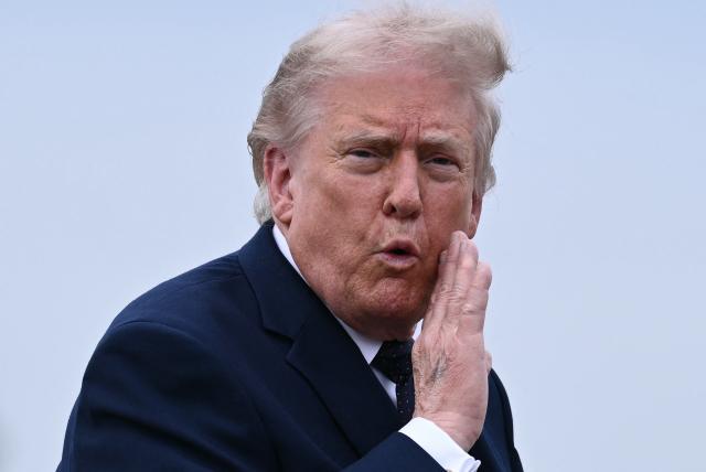 (FILES) US President Donald Trump gestures as he walks to board a plane at Morristown Airport in Morristown, New Jersey, on May 22, 2026. US President Donald Trump said on May 23 a deal with Iran had been "largely negotiated," with the proposal including opening the crucial Strait of Hormuz, though the agreement was "subject to finalization." (Photo by Brendan SMIALOWSKI / AFP)