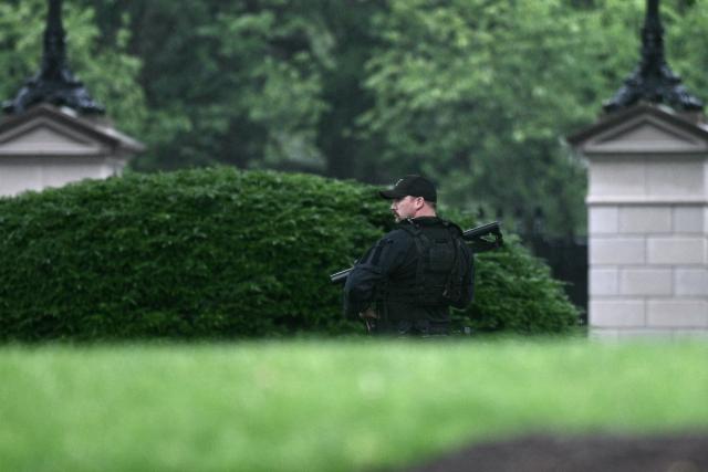 An armed Secret Service agent looks on at the White House in Washington, DC, after gunshots were apparently heard on May 23, 2026. (Photo by Brendan SMIALOWSKI / AFP)