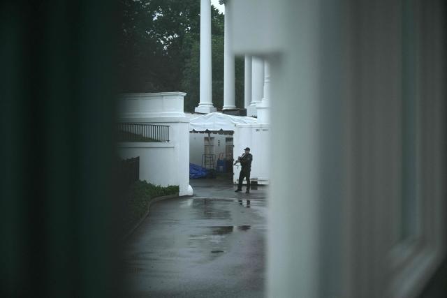 An armed Secret Service agent is seen on the grounds of the White House in Washington, DC, after gunshots were apparently heard on May 23, 2026. (Photo by Brendan SMIALOWSKI / AFP)