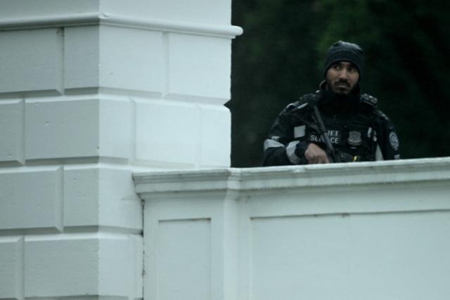 An armed Secret Service agent looks on at the White House in Washington, DC, after gunshots were apparently heard on May 23, 2026. (Photo by Brendan SMIALOWSKI / AFP)