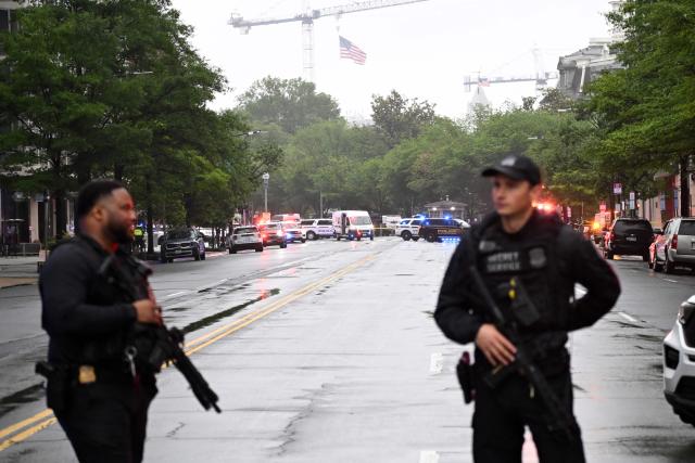 Police vehicles and armed Secret Service agents are seen near the White House in Washington, DC, on May 23, 2026. Police and security forces swarmed the area around the White House on the evening of May 23 after reports of shots fired, AFP journalists said. US President Donald Trump was at the White House at the time as he worked to negotiate a deal with Iran. (Photo by Alex WROBLEWSKI / AFP)