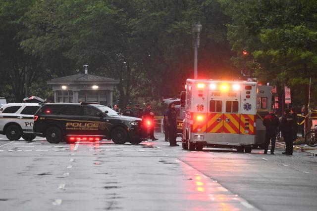 Emergency and police vehicles are seen near the White House in Washington, DC, on May 23, 2026. Police and security forces swarmed the area around the White House on the evening of May 23 after reports of shots fired, AFP journalists said. US President Donald Trump was at the White House at the time as he worked to negotiate a deal with Iran. (Photo by Alex WROBLEWSKI / AFP)