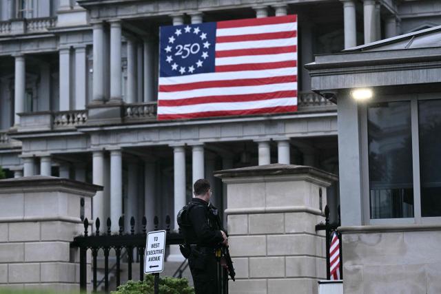 An armed Secret Service agent stands next to the Eisenhower Executive Office Building near the White House in Washington, DC, on May 23, 2026. Police and security forces swarmed the area around the White House on the evening of May 23 after reports of shots fired, AFP journalists said. US President Donald Trump was at the White House at the time as he worked to negotiate a deal with Iran. (Photo by Brendan SMIALOWSKI / AFP)