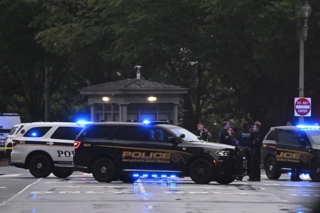 Police vehicles are seen near the White House in Washington, DC, on May 23, 2026. Police and security forces swarmed the area around the White House on the evening of May 23 after reports of shots fired, AFP journalists said. US President Donald Trump was at the White House at the time as he worked to negotiate a deal with Iran. (Photo by Alex WROBLEWSKI / AFP)