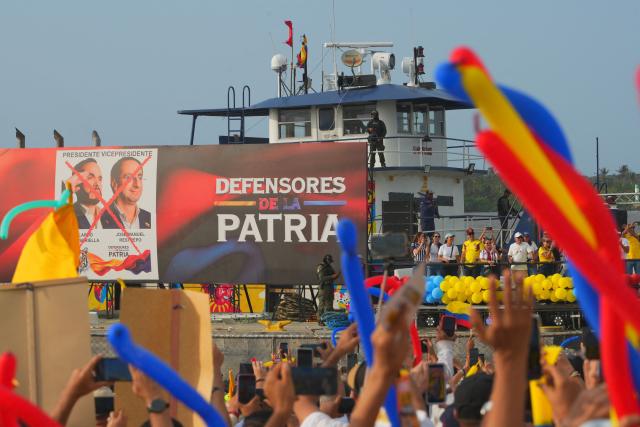 Members of the Colombian Navy stand guard in front of supporters of Colombia's presidential candidate for the Defensores de la Patria party, Abelardo de la Espriella, awaiting his arrival at his last campaign rally in Barranquilla, Colombia, on May 23, 2026. Colombia will hold presidential elections on May 31. (Photo by Vanessa ROMERO / AFP)