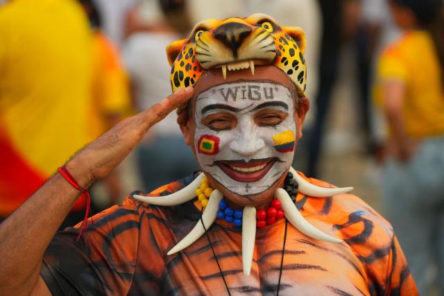 A supporter of Colombia's presidential candidate for the Defensores de la Patria party, Abelardo de la Espriella, dressed as a tiger gestures as he awaits his arrival at his last campaign rally in Barranquilla, Colombia, on May 23, 2026. Colombia will hold presidential elections on May 31. (Photo by Vanessa ROMERO / AFP)