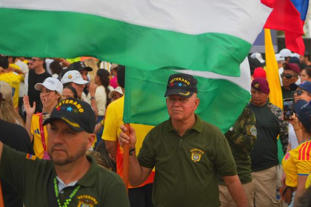 Veterans of the armed forces wave flags before the beginning of Colombia's presidential candidate for the Defensores de la Patria party, Abelardo de la Espriella's, last campaign rally in Barranquilla on May 23, 2026. Colombia will hold presidential elections on May 31. (Photo by Vanessa ROMERO / AFP)