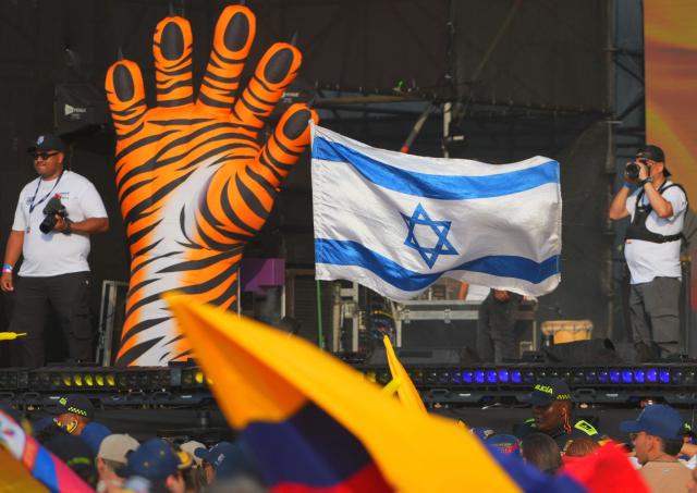 An Israeli flag waves while supporters of Colombia's presidential candidate for the Defensores de la Patria party, Abelardo de la Espriella, await his arrival to his last campaign rally in Barranquilla, Colombia, on May 23, 2026. Colombia will hold presidential elections on May 31. (Photo by Vanessa ROMERO / AFP)
