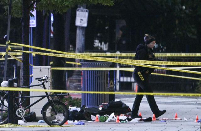 Police tape blocks off a crime scene with evidence markers seen on a sidewalk on 17th and Pennsylvania Ave near the White House in Washington, DC, on May 23, 2026. Police and security forces swarmed the area around the White House on the evening of May 23 after reports of shots fired, AFP journalists said. US President Donald Trump was at the White House at the time as he worked to negotiate a deal with Iran. (Photo by Brendan SMIALOWSKI / AFP)
