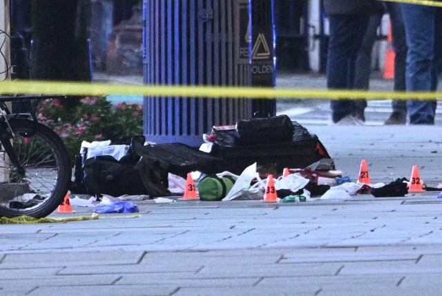 Police tape blocks off a crime scene with evidence markers seen on a sidewalk on 17th and Pennsylvania Ave near the White House in Washington, DC, on May 23, 2026. Police and security forces swarmed the area around the White House on the evening of May 23 after reports of shots fired, AFP journalists said. US President Donald Trump was at the White House at the time as he worked to negotiate a deal with Iran. (Photo by Brendan SMIALOWSKI / AFP)