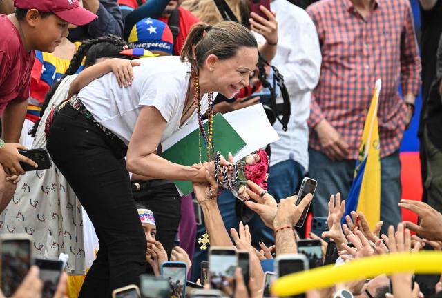 Venezuelan opposition leader Maria Corina Machado greets members of the Venezuelan diaspora during a rally in Panama City on May 23, 2026. Machado is visiting Panama as part of a regional tour, during which she is set to meet with members of the Venezuelan diaspora and Panamanian President Jose Raul Mulino. (Photo by MARTIN BERNETTI / AFP)