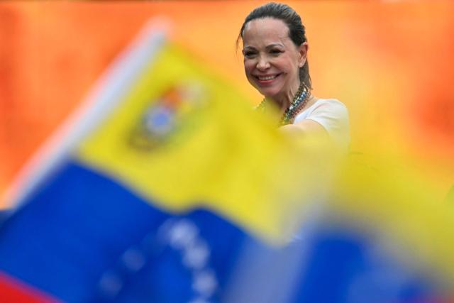 Venezuelan opposition leader Maria Corina Machado smiles to supporters during a rally with Venezuelan diaspora in Panama City on May 23, 2026. Machado is visiting Panama as part of a regional tour, during which she is set to meet with members of the Venezuelan diaspora and Panamanian President Jose Raul Mulino. (Photo by MARTIN BERNETTI / AFP)