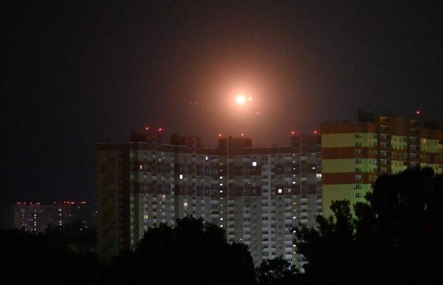 This photo shows Ukrainian air defence firing at Russian drones above Kyiv during a Russian drone and missile strike on the Ukrainian capital on May 24, 2026, amid the Russian invasion in Ukraine. A large ballistic missile attack pounded Kyiv early on May 24, authorities said, wounding at least five people after Moscow threatened retaliation for strikes in Russian-occupied eastern Ukraine. (Photo by Sergei SUPINSKY / AFP)