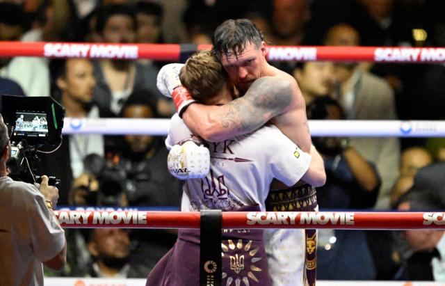 Ukraine's Oleksandr Usyk celebrates with a mamber of his team after defeating Netherlands' Rico Verhoeven by TKO during their WBC World Heavyweight Championship 'Glory in Giza' boxing match at the Pyramids of Giza on May 23, 2026. Heavyweight boxing king Oleksandr Usyk retained his titles after a dramatic and controversial stoppage victory over kick-boxer Rico Verhoeven with a second left of the 11th round in Egypt on May 23. (Photo by Khaled DESOUKI / AFP)